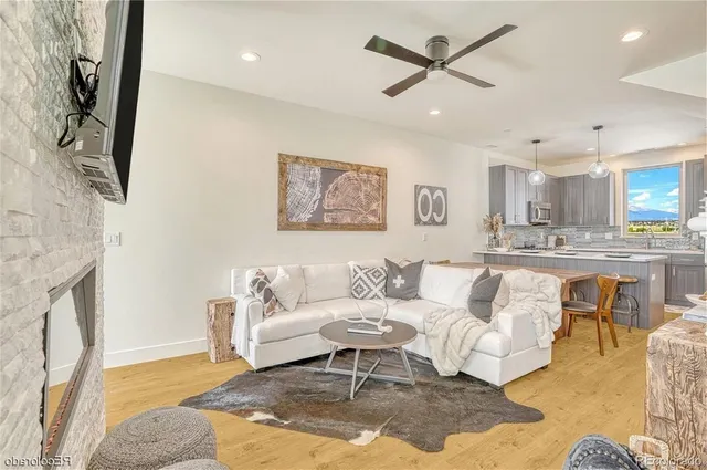 a living room with furniture and kitchen view