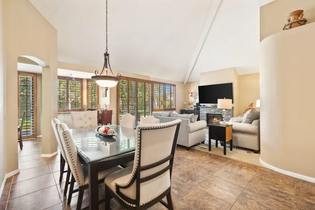 a large bedroom with a bed and a flat screen tv