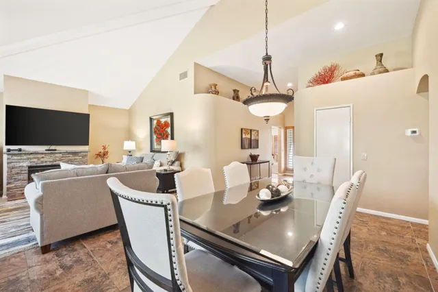 a kitchen with stainless steel appliances granite countertop a sink refrigerator and cabinets