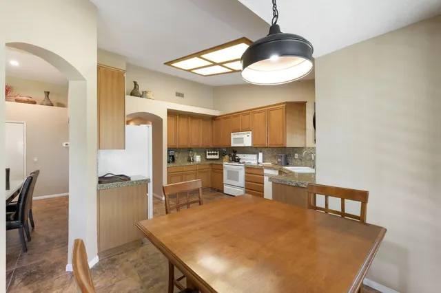 a spacious bathroom with a double vanity sink a mirror and a bathtub