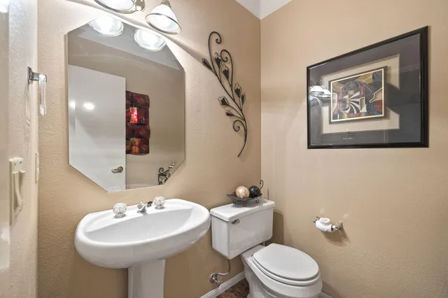 a view of a white house with a big yard and palm trees