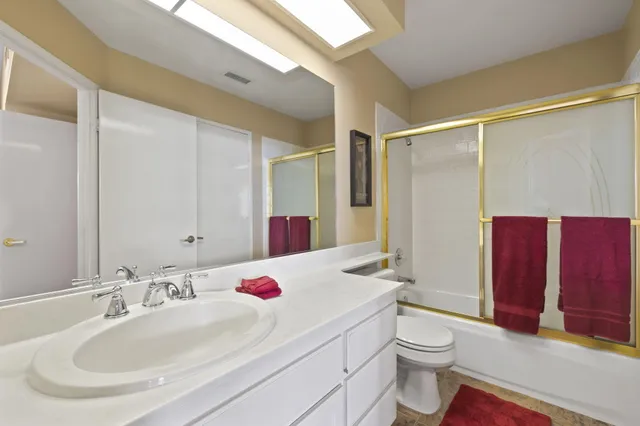 a view of a patio with table and chairs under an umbrella