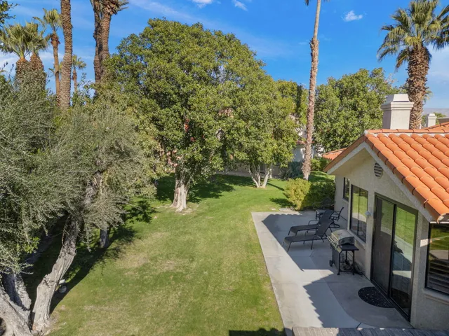 a view of a house with backyard porch and sitting area