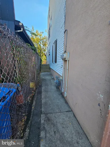 a view of backyard with tree and wooden fence