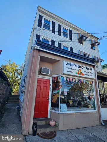a front view of building with retail shop and windows