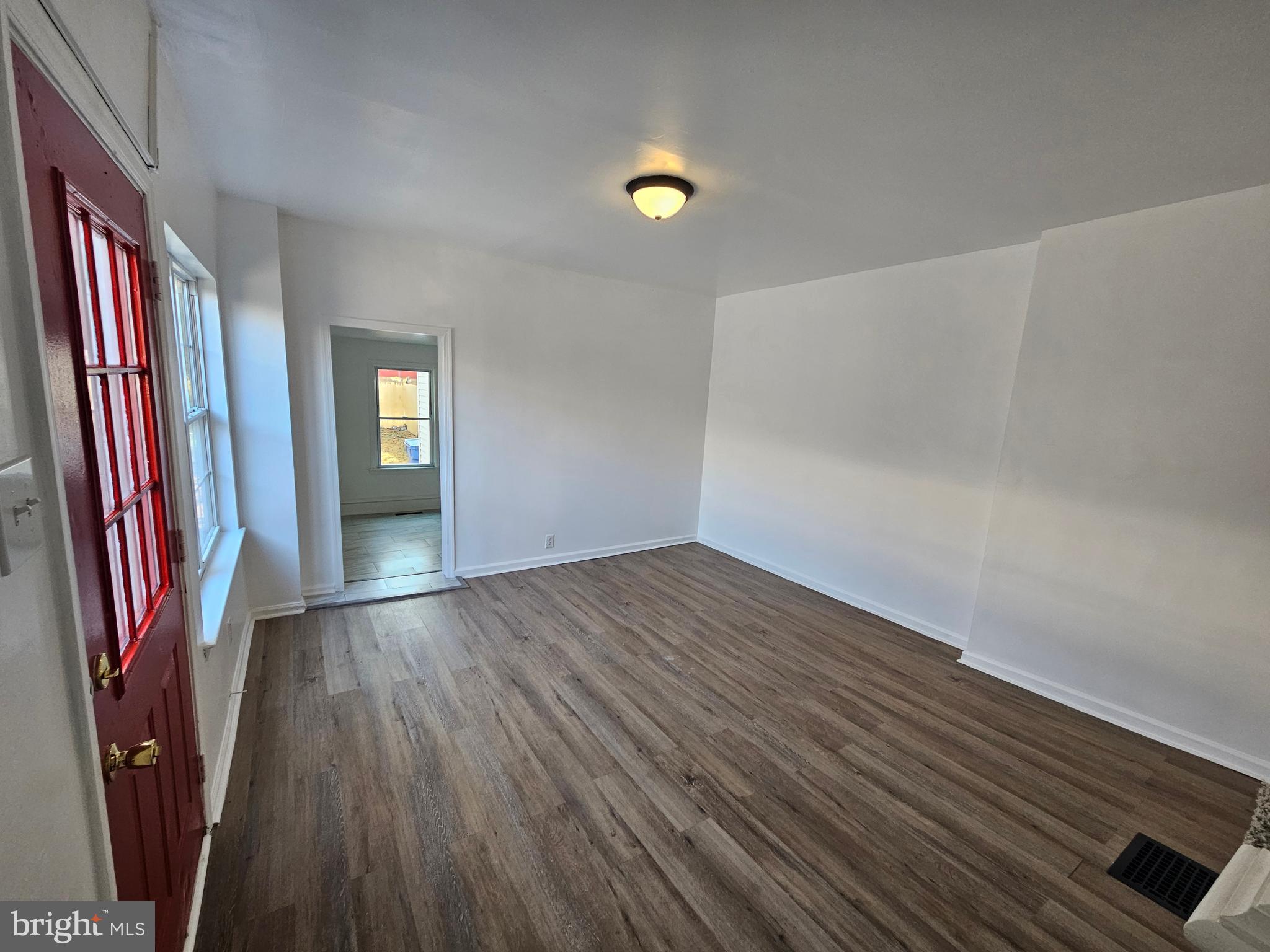 221 Broadway Westville, NJ 08093 - Photo 25 of 51 wooden floor in an empty room with a window