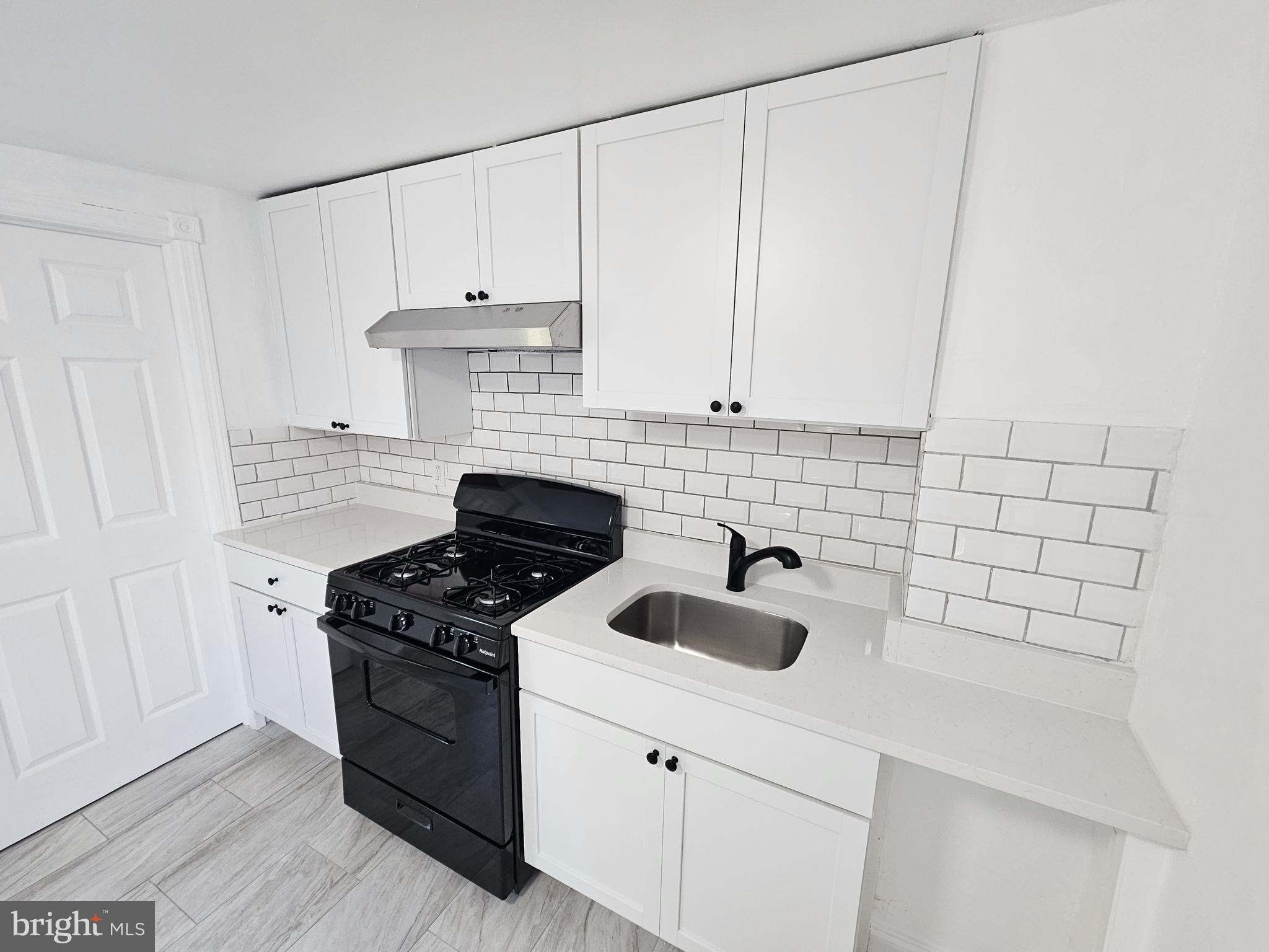 221 Broadway Westville, NJ 08093 - Photo 32 of 51 a kitchen with cabinets and appliances