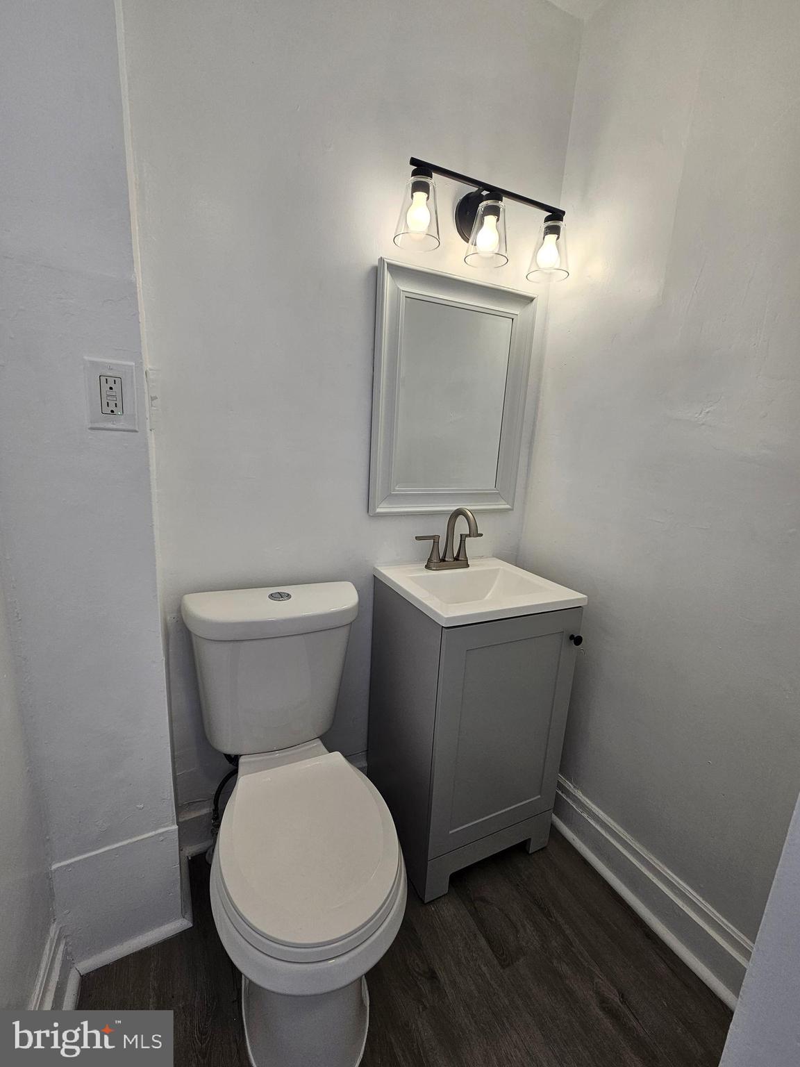 221 Broadway Westville, NJ 08093 - Photo 44 of 51 a bathroom with a toilet sink and mirror