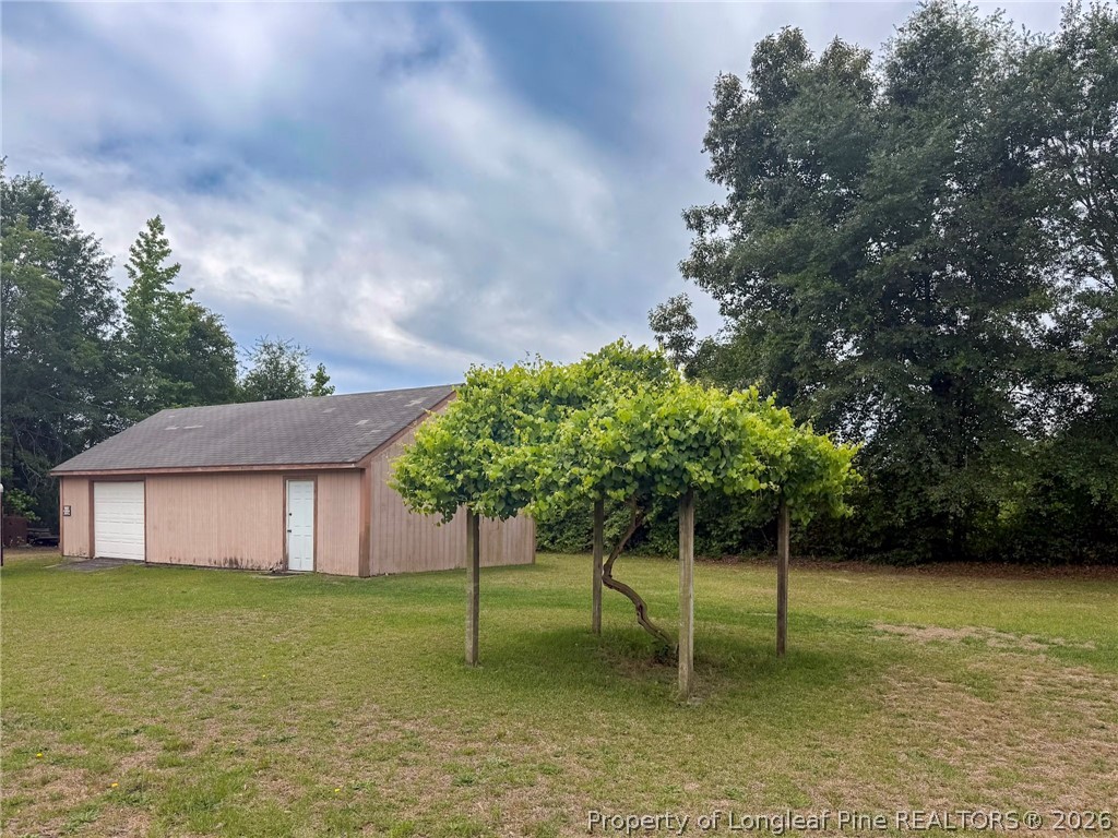 1308 Mac D Road Orrum, NC 28369 - Photo 2 of 32 a house with a tree in a yard