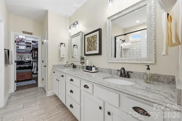 a bathroom with double vanity sink and a mirror