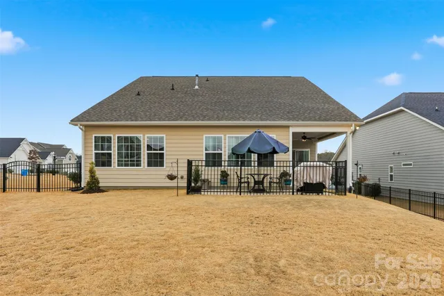 a view of a house with a yard and sitting area
