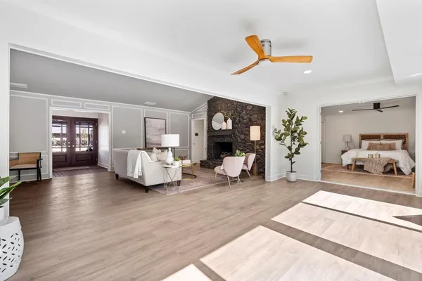 a bedroom with furniture and a wooden floor