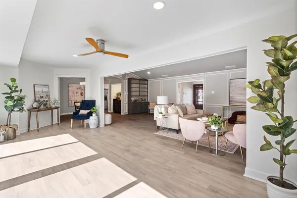 a living room with furniture and wooden floor