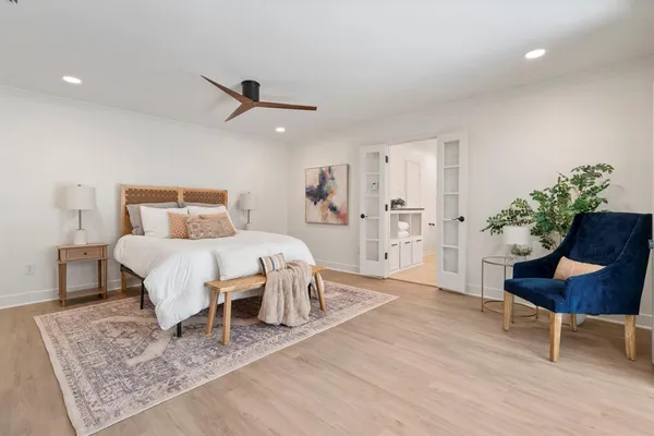 a bed room with a bed and a chair