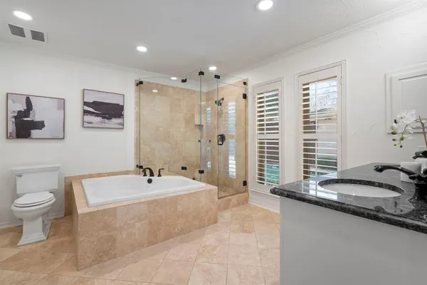 a spacious bathroom with a tub sink and mirror