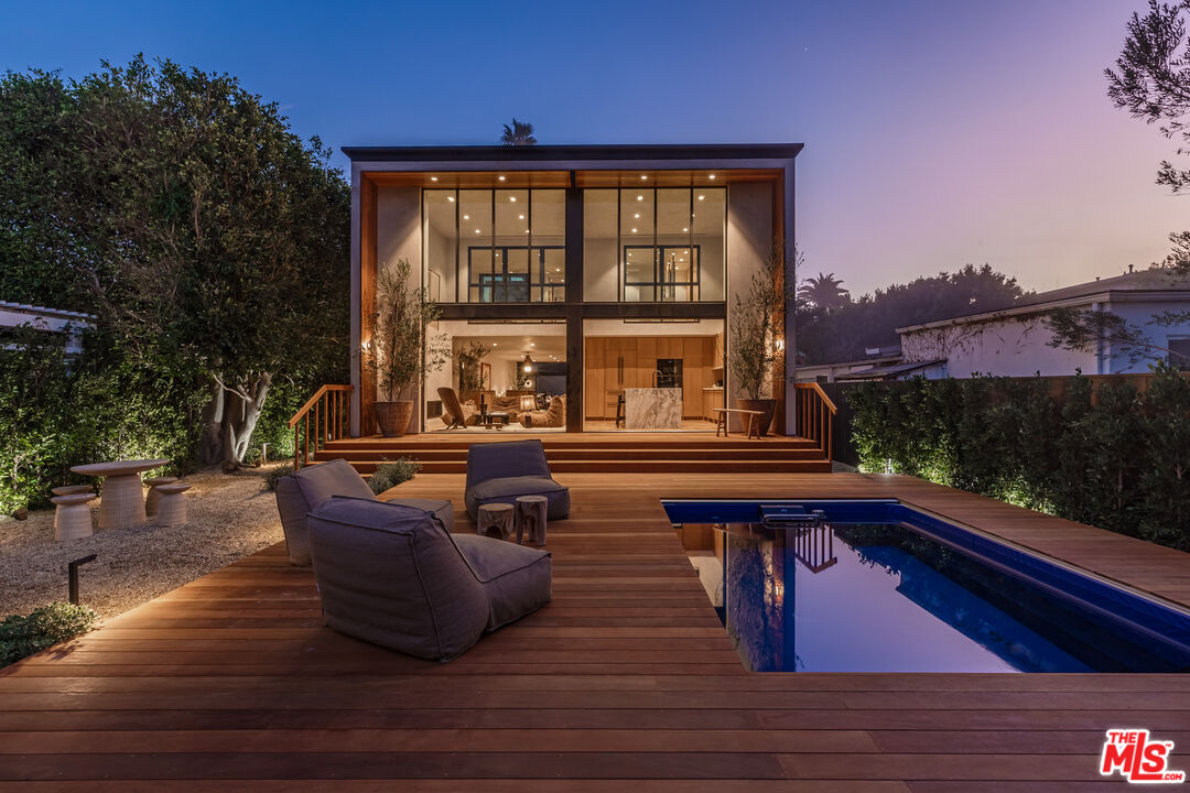 23505 Malibu Colony Road Malibu, CA 90265 - Photo 1 of 39 a view of swimming pool with seating space and wooden floor