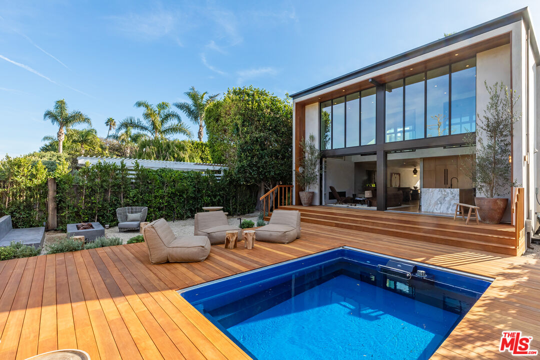 23505 Malibu Colony Road Malibu, CA 90265 - Photo 17 of 39 a view of a house with pool and wooden floor
