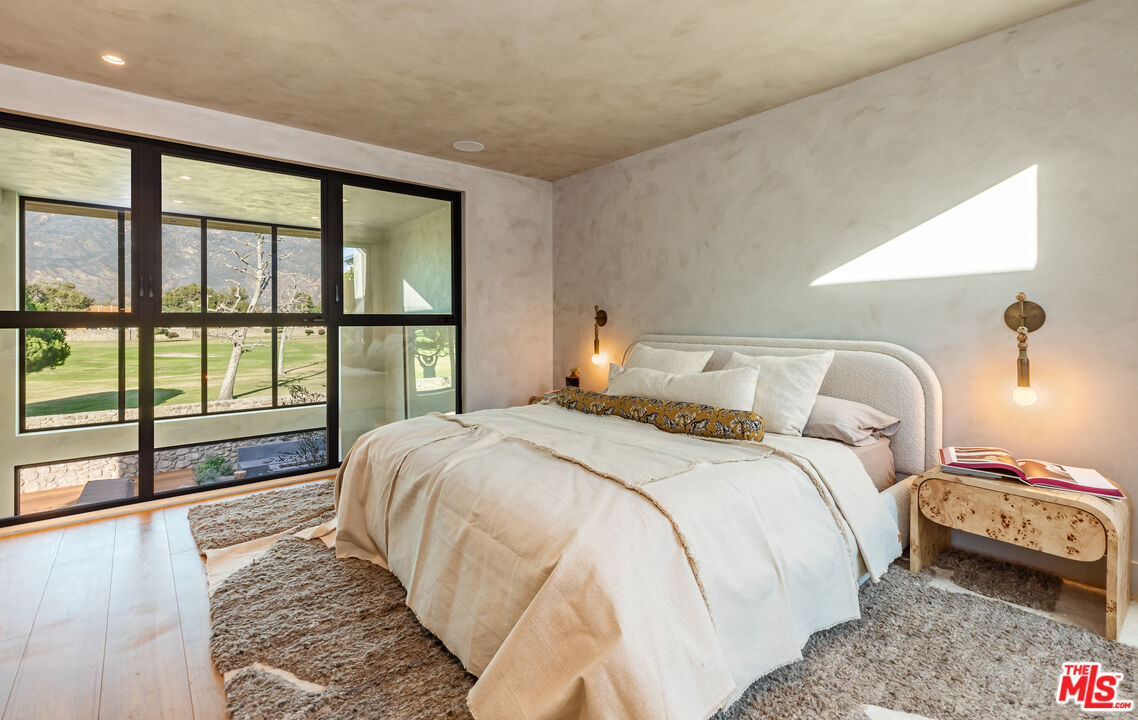 23505 Malibu Colony Road Malibu, CA 90265 - Photo 26 of 39 a bedroom with a large bed and a large window