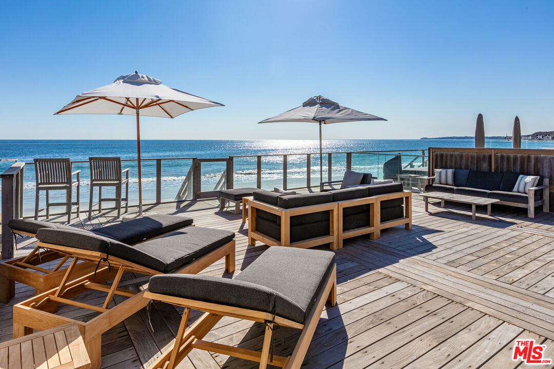 23505 Malibu Colony Road Malibu, CA 90265 - Photo 4 of 39 a view of a chairs and table on the wooden roof deck
