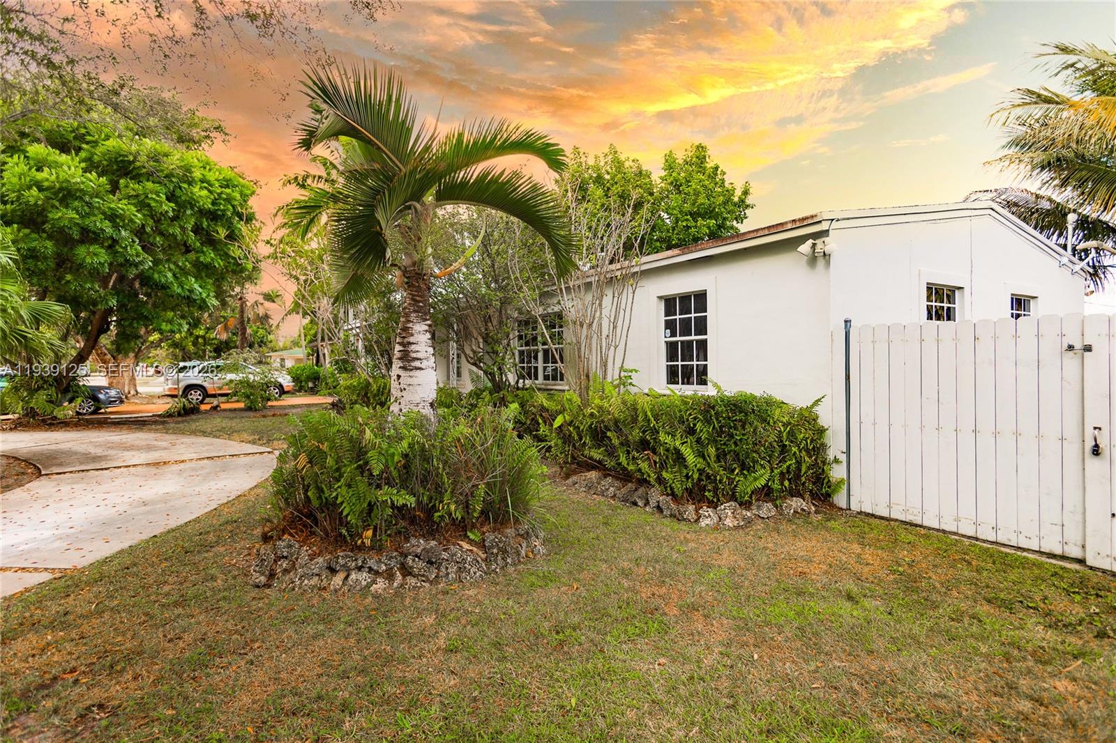 6765 Southwest 51st Street Miami, FL 33155 - Photo 14 of 43 a view of a house with a yard and potted plants
