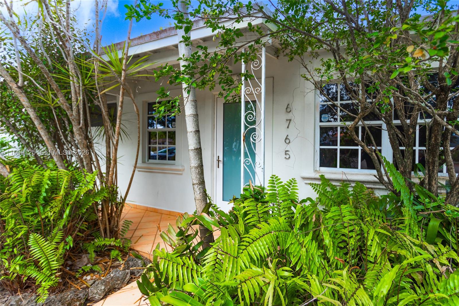 6765 Southwest 51st Street Miami, FL 33155 - Photo 15 of 43 a front view of a house with a yard