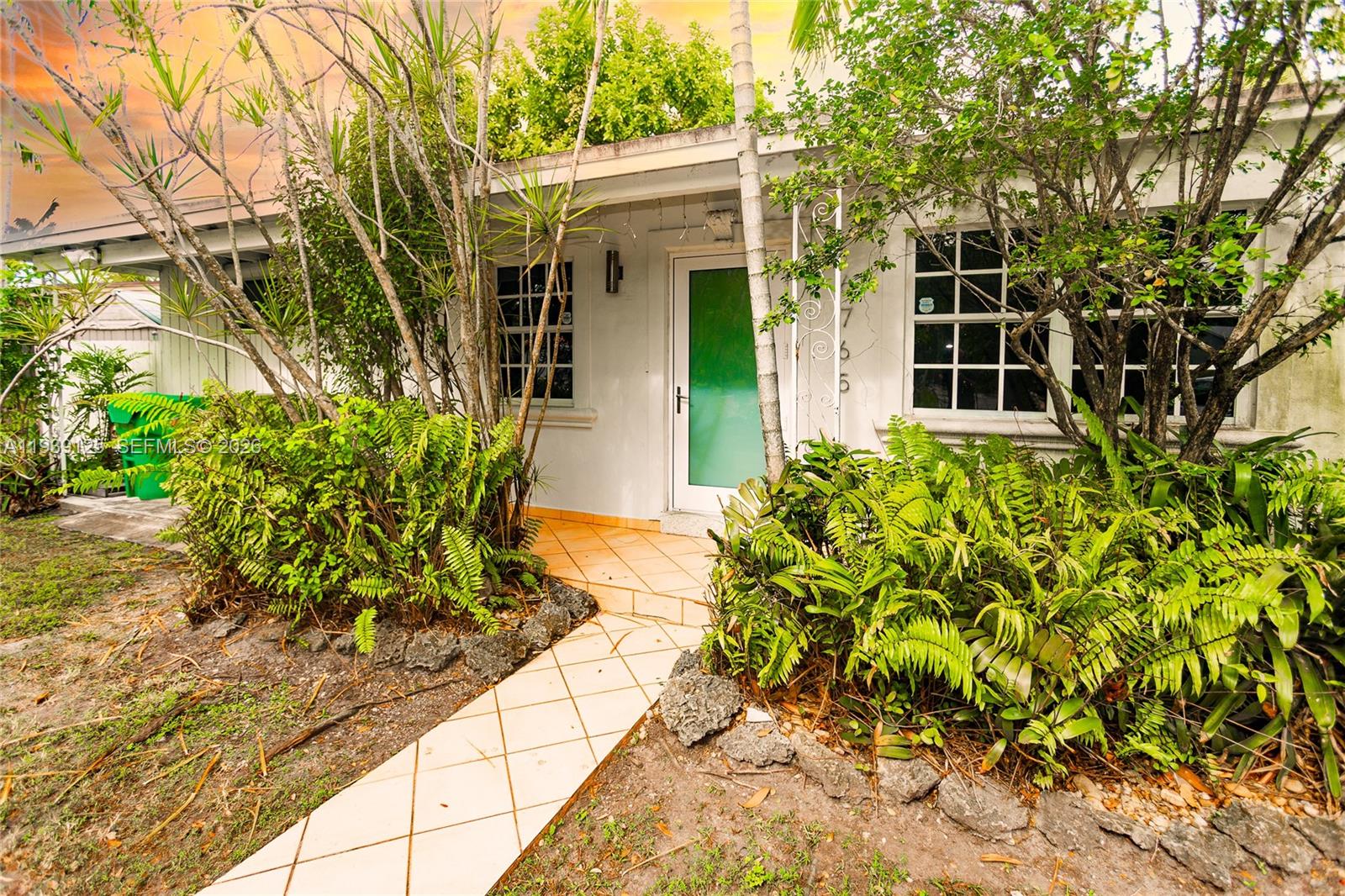 6765 Southwest 51st Street Miami, FL 33155 - Photo 16 of 43 a front view of a house with a yard
