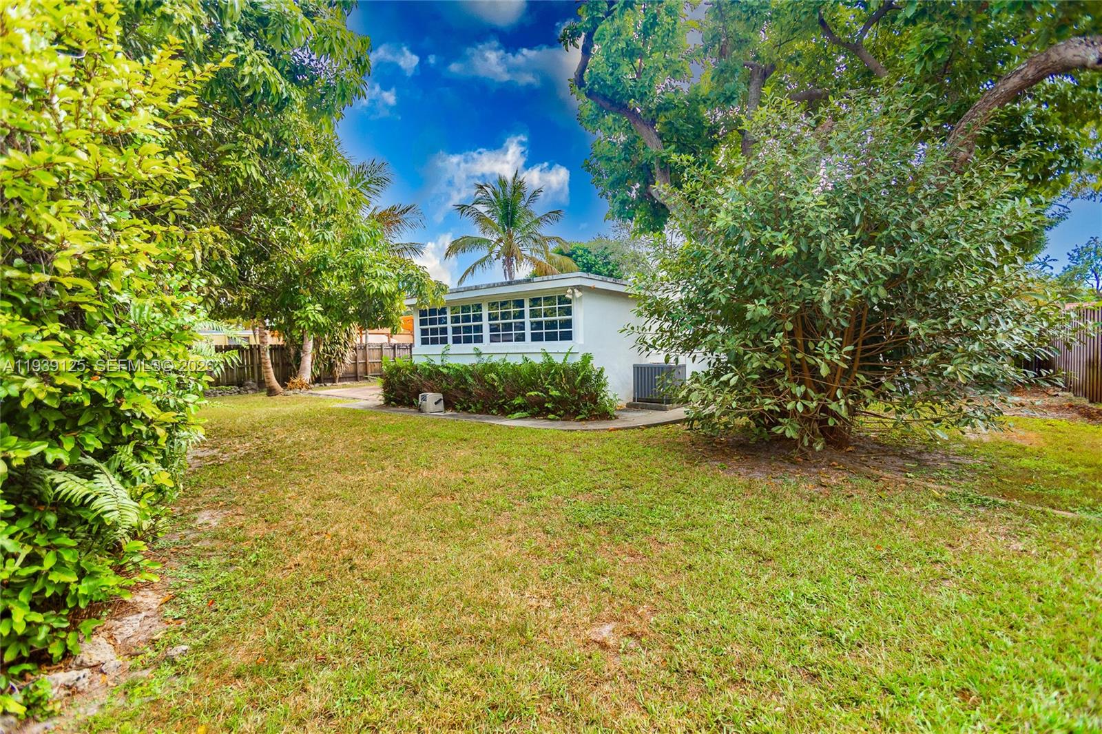 6765 Southwest 51st Street Miami, FL 33155 - Photo 20 of 43 a front view of a house with a garden