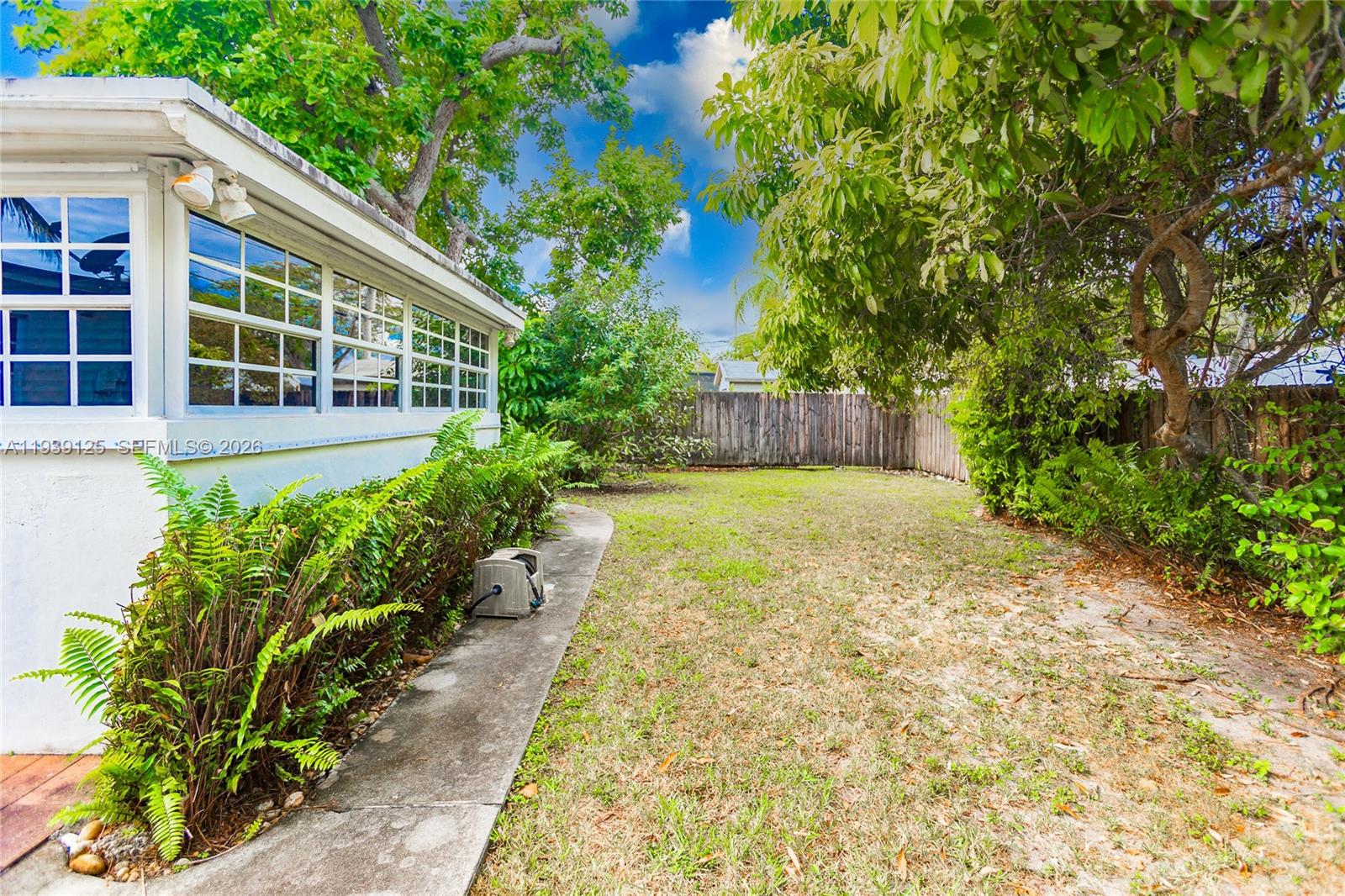 6765 Southwest 51st Street Miami, FL 33155 - Photo 26 of 43 a view of a house with potted plants and large trees