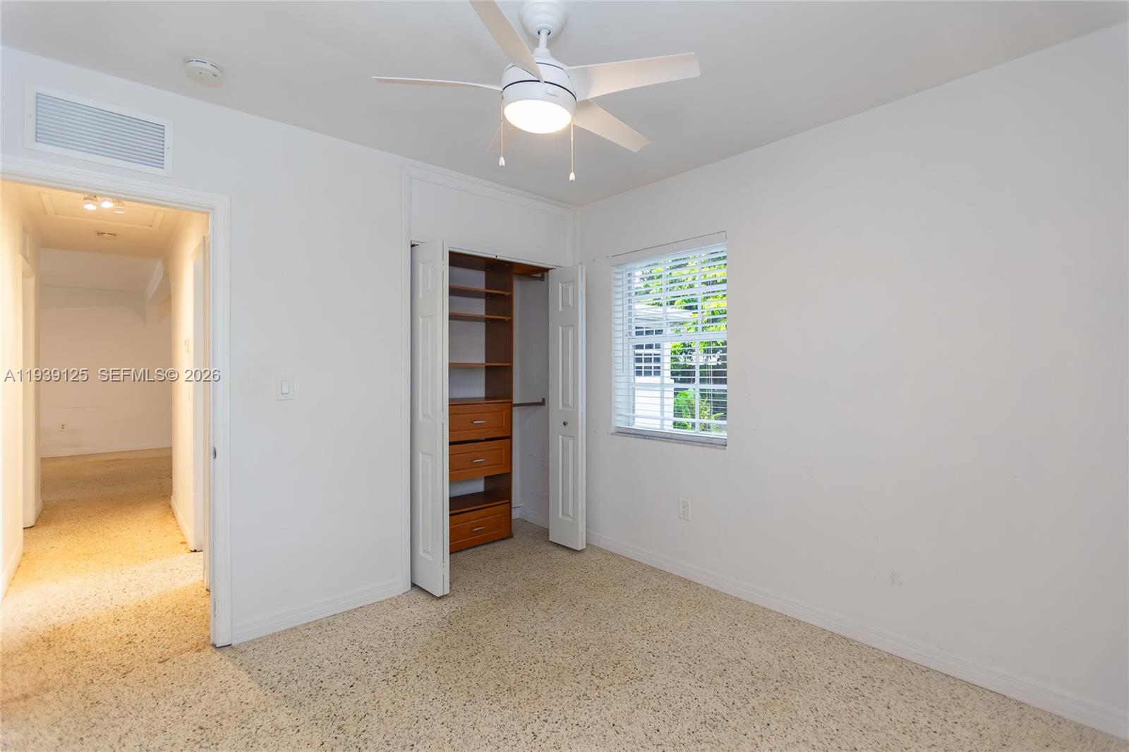 6765 Southwest 51st Street Miami, FL 33155 - Photo 40 of 43 an empty room with closet and a ceiling fan