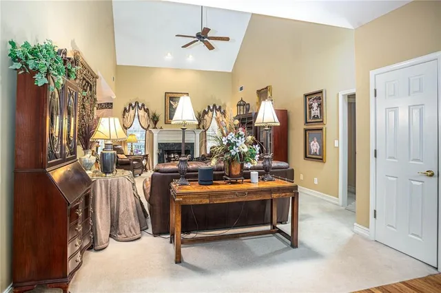 a bedroom with a bed a chair and next to a window