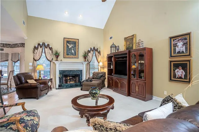 a bedroom with a bed and a lamp on dresser