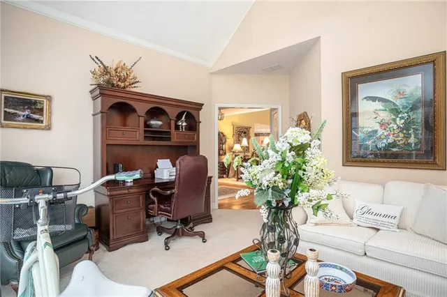 a living room with furniture a fireplace and wall paintings