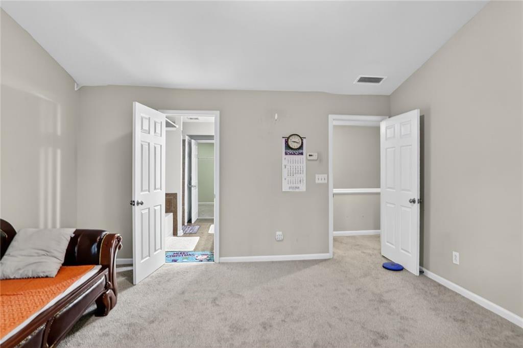 3053 Hartright Bend Court Duluth, GA 30096 - Photo 13 of 24 a bed room with a bed and a couch