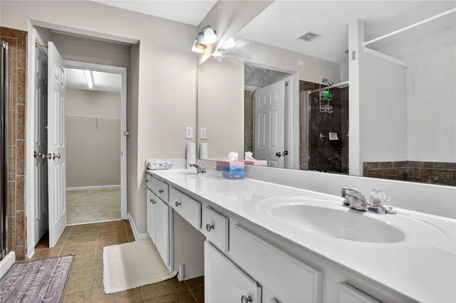 a bathroom with double vanity sink and a mirror