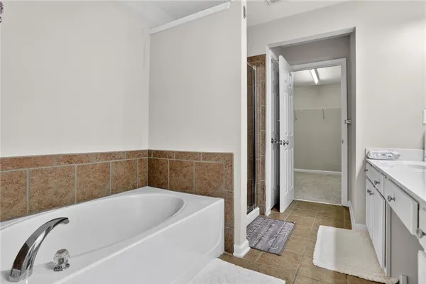 a bathroom with a bathtub and a shower