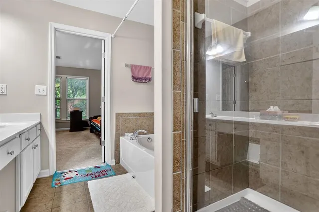a en suite bathroom with a granite countertop shower and a sink