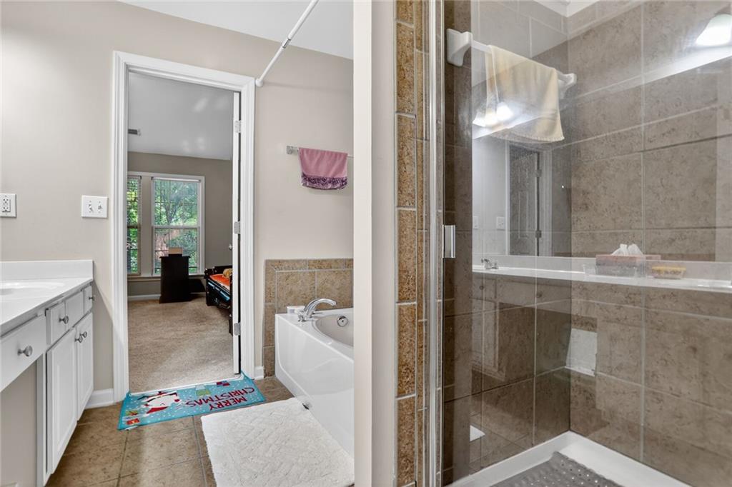 3053 Hartright Bend Court Duluth, GA 30096 - Photo 16 of 24 a en suite bathroom with a granite countertop shower and a sink