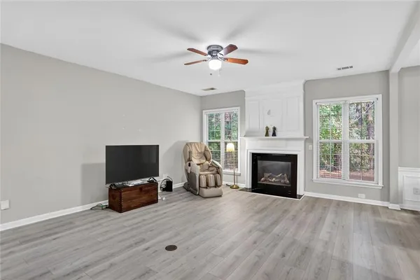 a living room with furniture fireplace and flat screen tv