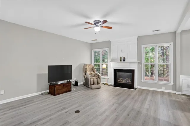 a living room with furniture fireplace and flat screen tv
