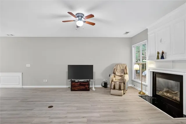 a living room with furniture a fireplace and flat screen tv