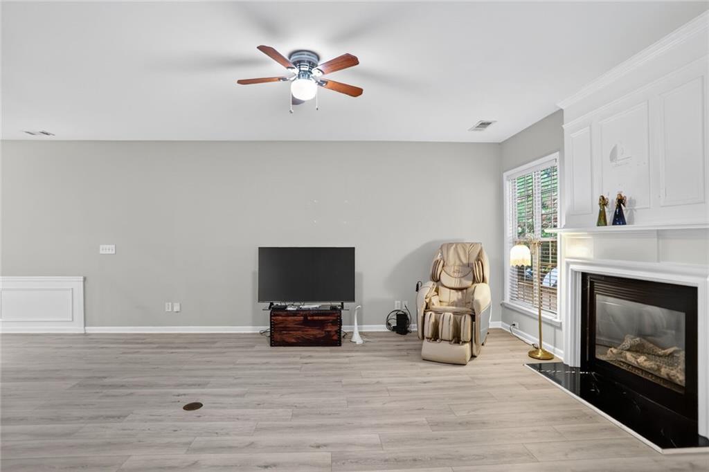 3053 Hartright Bend Court Duluth, GA 30096 - Photo 4 of 24 a living room with furniture a fireplace and flat screen tv
