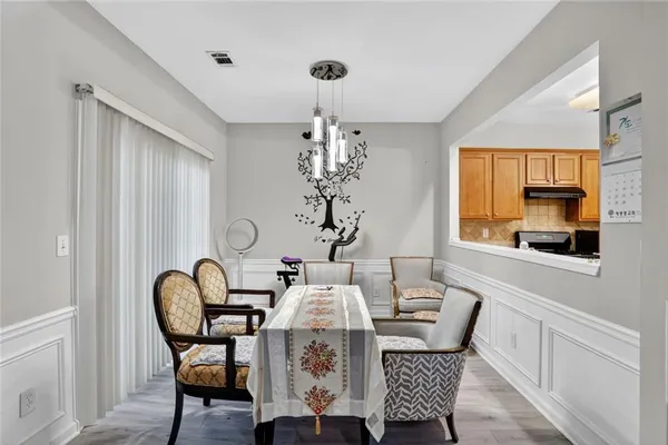 a view of a dining room with furniture window and wooden floor