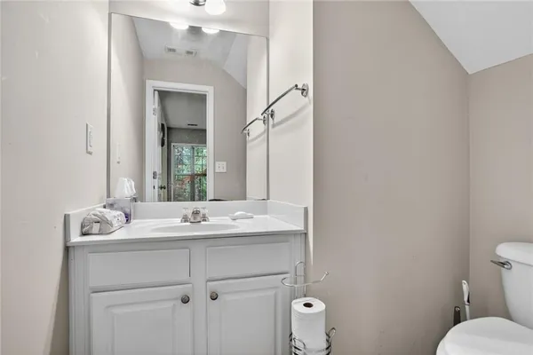 a bathroom with a sink toilet and mirror