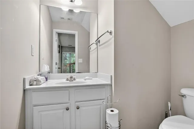 a bathroom with a sink toilet and mirror