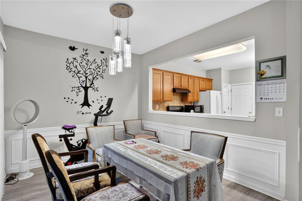 3053 Hartright Bend Court Duluth, GA 30096 - Photo 10 of 24 a living room with furniture and a chandelier