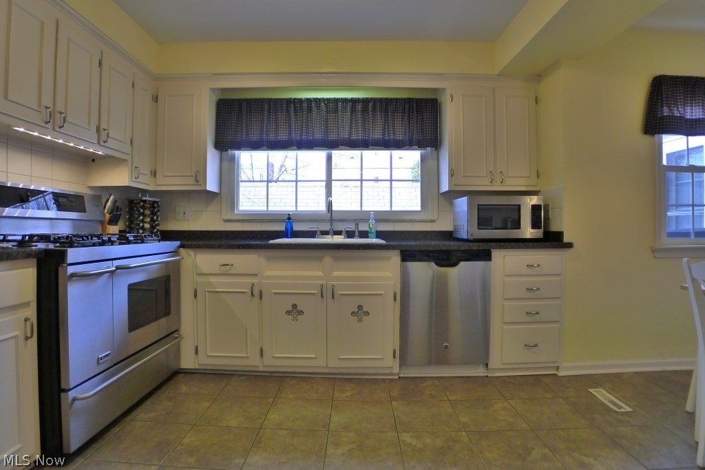 3306 Ardmore Road Cleveland, OH 44120 - Photo 11 of 33 The large professional grade gas range, along with other stainless steel appliances, perfectly compliment the beautiful white wood cabinetry