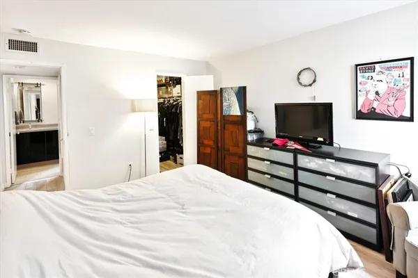 a bedroom with a bed and a flat screen tv