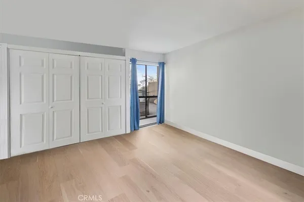 a view of an empty room with closet area