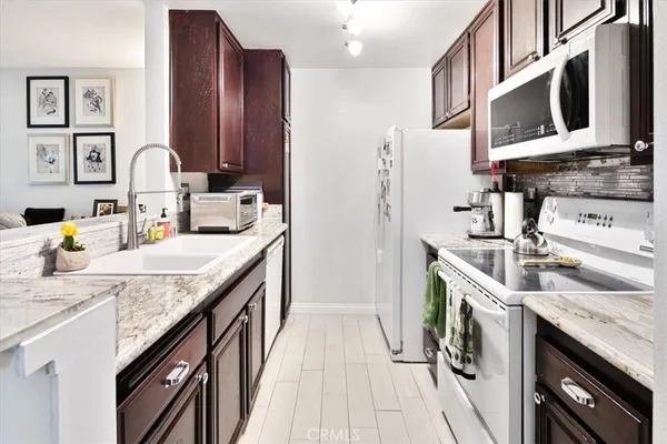 a kitchen with a sink stove and cabinets