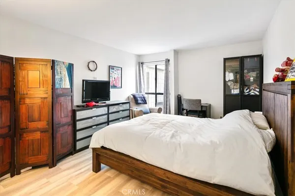 a bedroom with a bed and a flat screen tv
